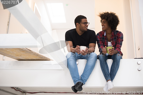 Image of couple having break during moving to new house