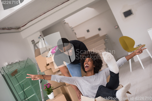 Image of African American couple  playing with packing material