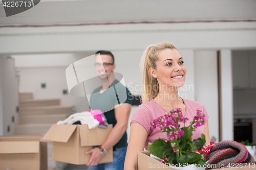 Image of young couple moving into a new home