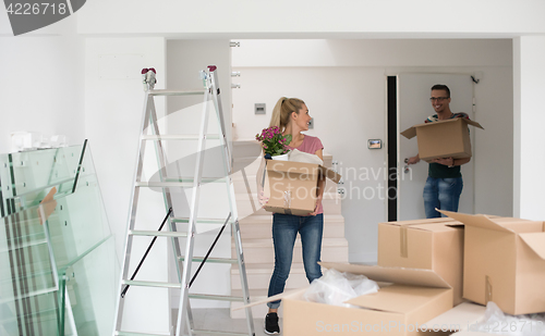 Image of young couple moving into a new home