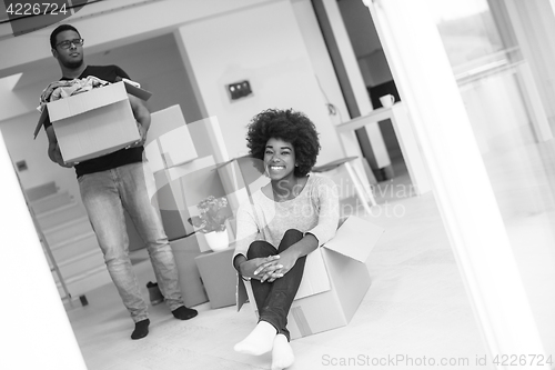 Image of African American couple  playing with packing material