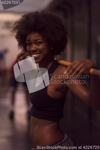 Image of black woman lifting empty bar