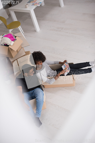 Image of African American couple  playing with packing material