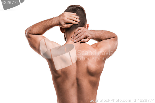 Image of Studio shot of man with pain in neck