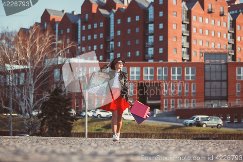 Image of The girl walking with shopping on city streets