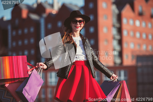 Image of The girl walking with shopping on city streets