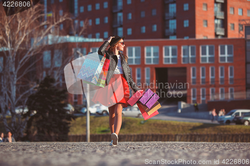 Image of The girl walking with shopping on city streets