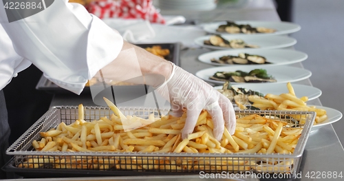 Image of French fries and meat on the table