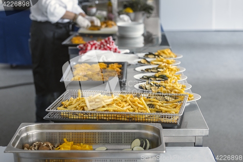 Image of French fries and meat on the table