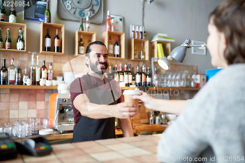 Image of man or waiter serving customer in coffee shop