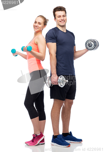 Image of sportive man and woman with dumbbells