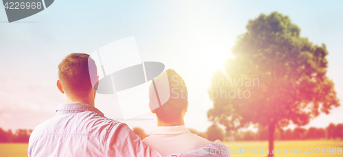 Image of close up of happy male gay couple hugging