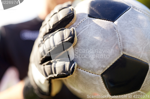 Image of close up of goalkeeper with ball playing football