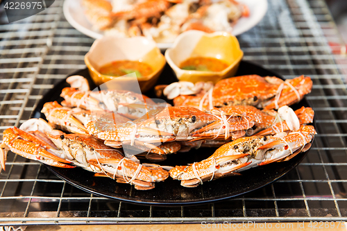 Image of grilled crabs on plate at street market