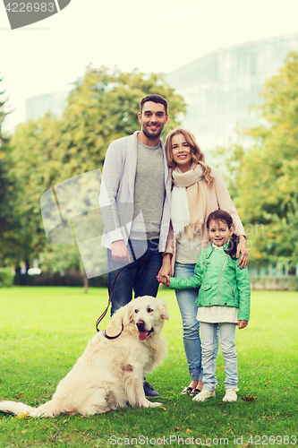 Image of happy family with labrador retriever dog in park