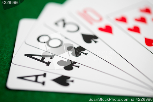 Image of poker hand of playing cards on green casino cloth