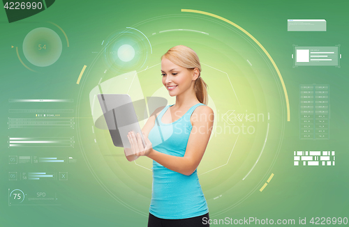 Image of happy smiling sporty woman with tablet pc