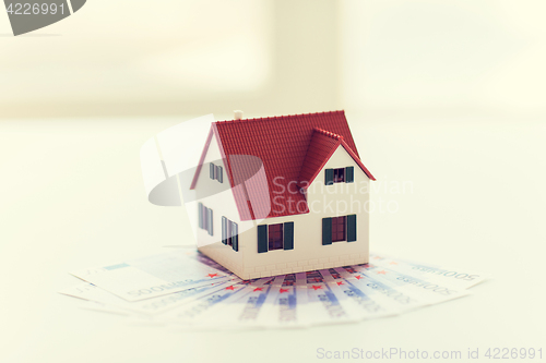 Image of close up of home or house model and money