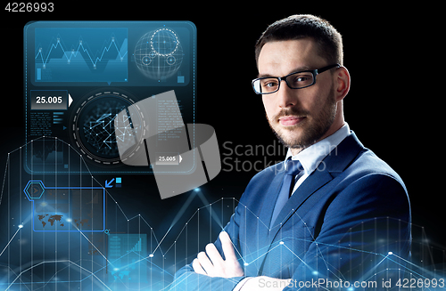 Image of businessman in glasses with virtual charts