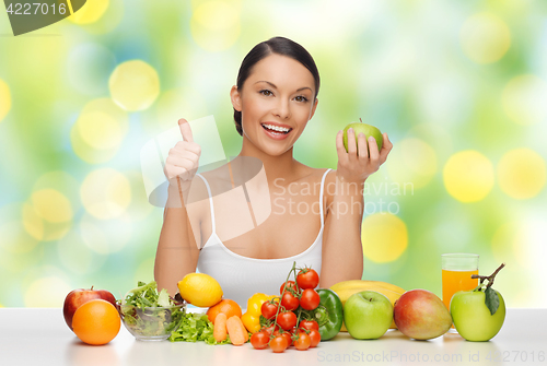 Image of woman with fruits and vegetables showing thumbs up