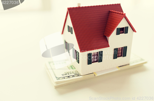 Image of close up of home or house model and money