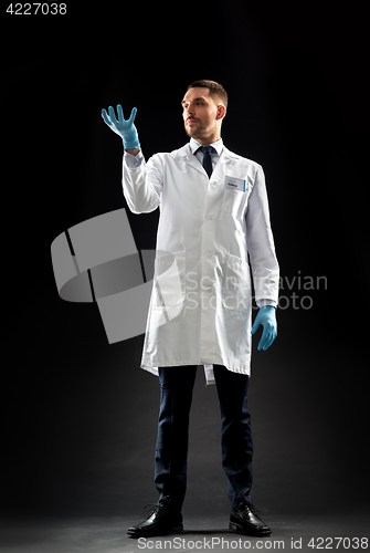 Image of doctor or scientist in lab coat and medical gloves