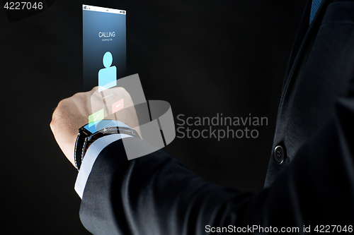 Image of close up of businessman hand with smartwatch