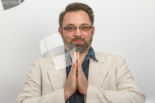 Image of Young businessman meditates in lunchtime