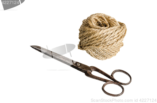 Image of Old scissors and twine, it is isolated on white