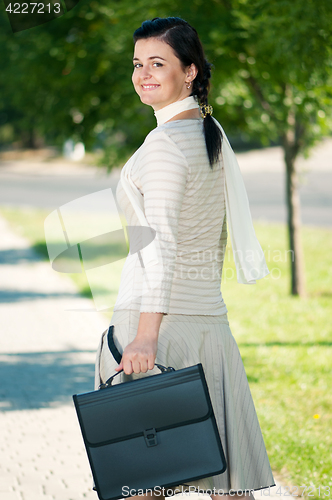 Image of Business woman in summer park