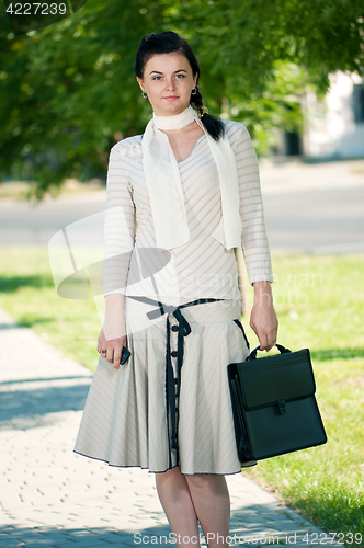 Image of Business woman in summer park