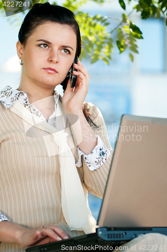 Image of Business woman in summer park