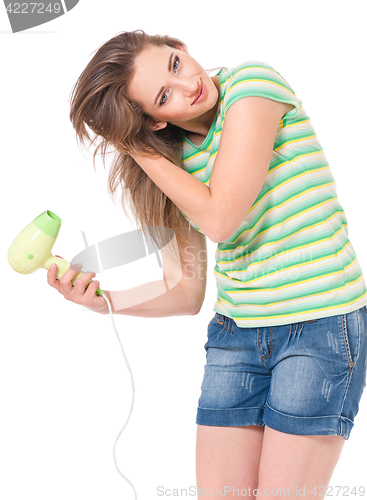 Image of Teen girl with hair dryer