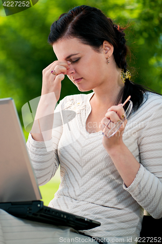 Image of Business woman in summer park