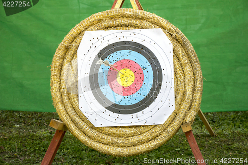 Image of Archery Target With Arrows On a straw background