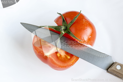 Image of Knife and cut tomato