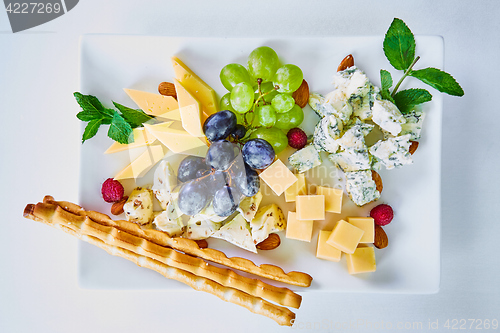 Image of cheese variation on a white table.