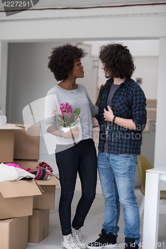 Image of multiethnic couple moving into a new home