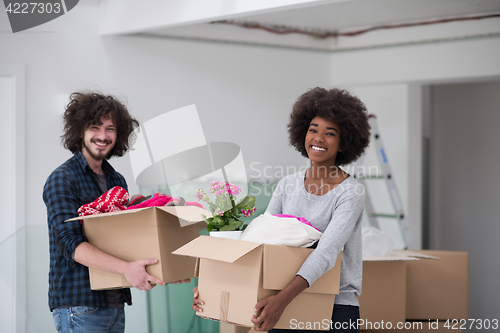 Image of multiethnic couple moving into a new home