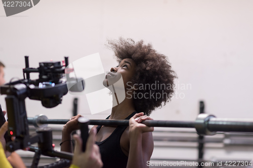 Image of black woman lifting empty bar