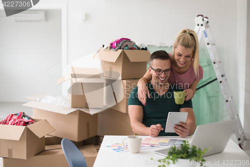 Image of Young couple moving in a new home