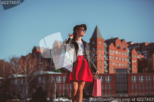 Image of The girl walking with shopping on city streets