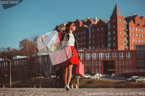 Image of The girl walking with shopping on city streets