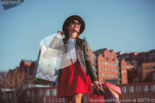 Image of The girl walking with shopping on city streets