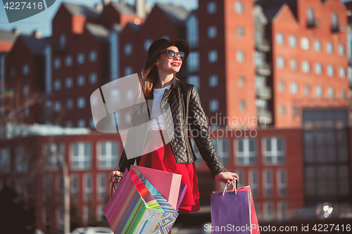 Image of The girl walking with shopping on city streets
