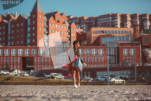 Image of The girl walking with shopping on city streets