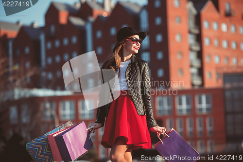 Image of The girl walking with shopping on city streets