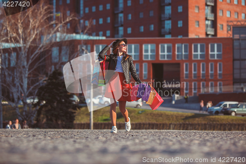 Image of The girl walking with shopping on city streets