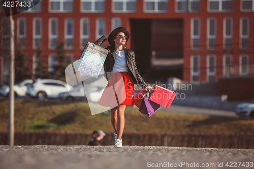 Image of The girl walking with shopping on city streets