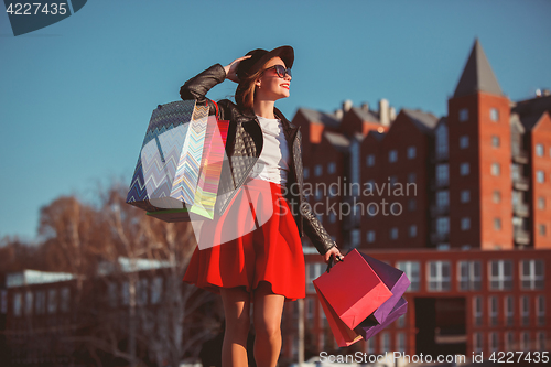 Image of The girl walking with shopping on city streets